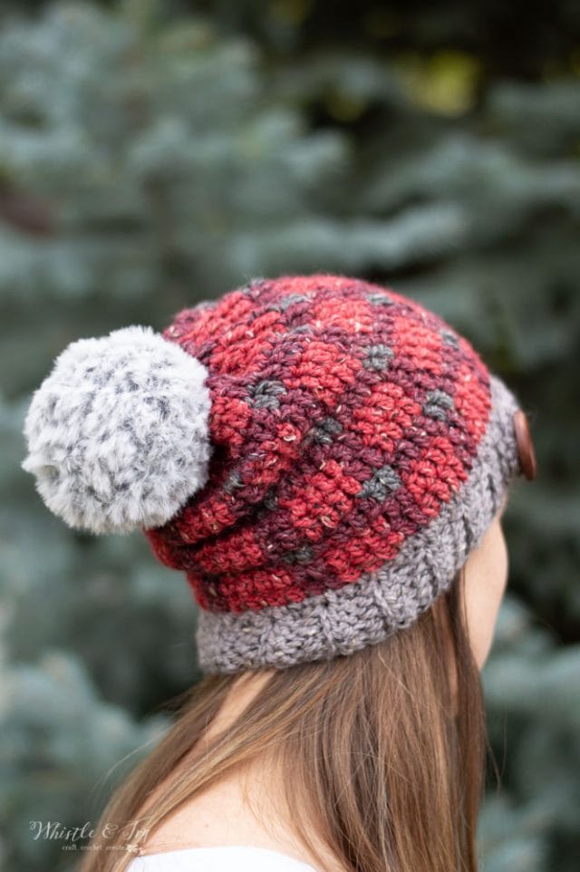 Plaid tartan hat -- a crocheted plaid beanie hat in shades of red with a big fur pom-pom