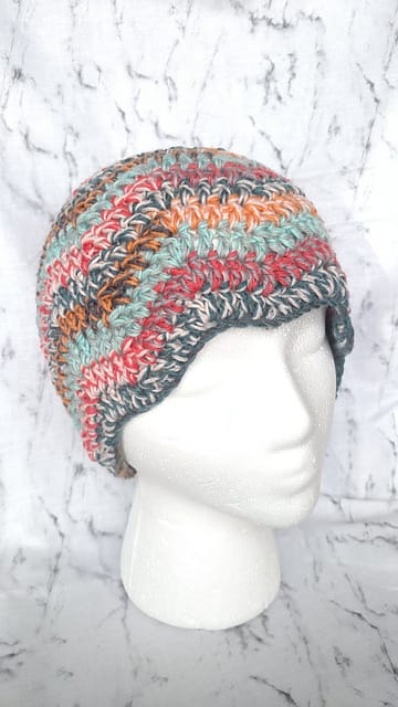 A picture of a colorful zigzag hat on a foam mannequin head.