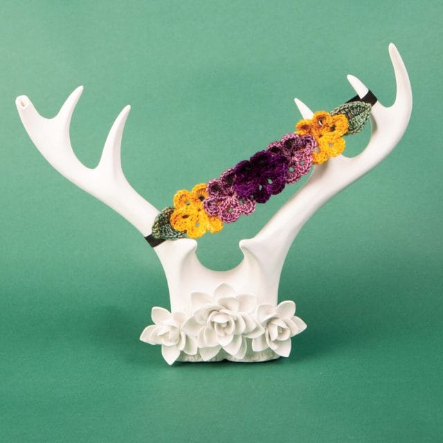 The crocheted flower crown displayed on some decorative white porcelain antlers