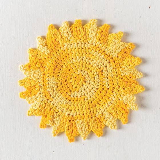 Yellow yarn crocheted into the shape of a sun.