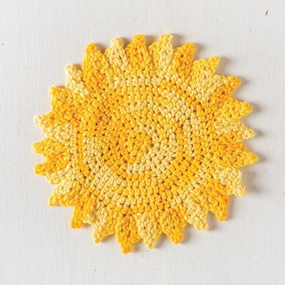 Yellow yarn crocheted into the shape of a sun.