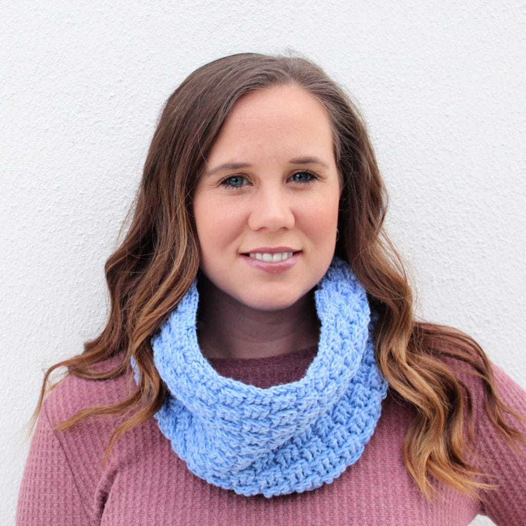 A headshot of Michelle Ferguson, a woman with long blonde hair, who is wearing a crocheted cowl around her neck.