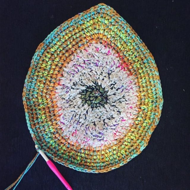 A top-down picture of an avocado-shaped crochet project