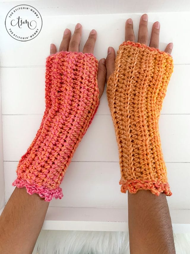 Tropical Sunset Fingerless Mitts by The Stitchin' Mommy. Two hands reach out to show off these sunset-colored crochet fingerless mitts.