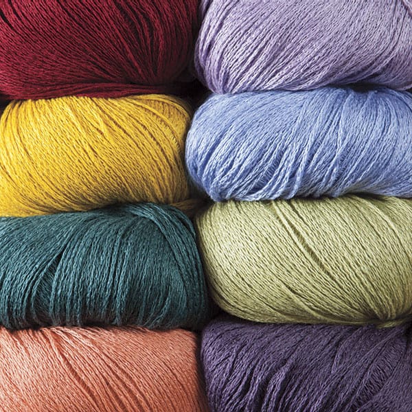 Eight balls of Lindy Chain yarn in various colors.