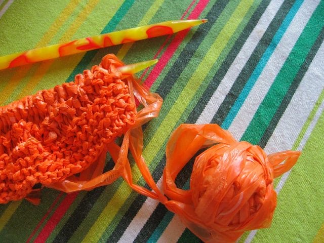 10 Thrifty Crochet Tips from the WeCrochet Blog at crochet.com. This photo shows: a knitted swatch alongside a ball of plarn (plastic yarn made of recycled plastic bags).