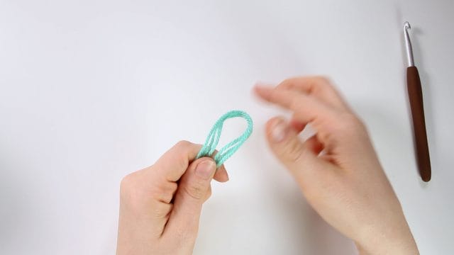 Make a slipknot, wrapping all 3 strands together.