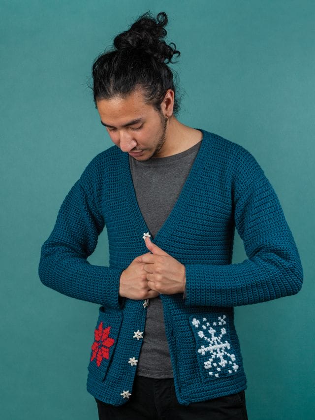 A model wears the Revelry crochet cardigan, a free holiday crochet pattern from crochet.com. A not-ugly sweater for the holidays.