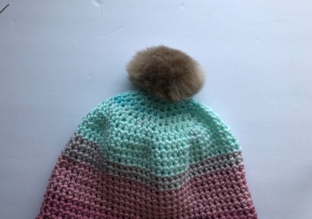 How to put a removable pom-pom on a hat.
