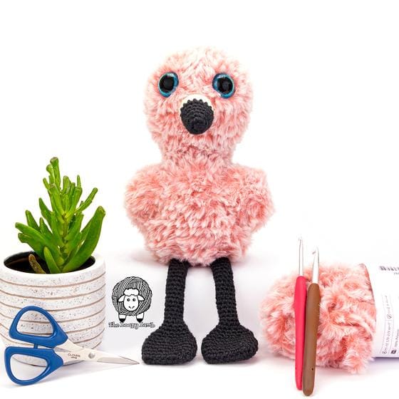 A crocheted flamingo toy in furry pink yarn