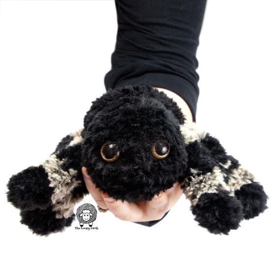 A crocheted spider toy made in black and gray Fable Fur yarn