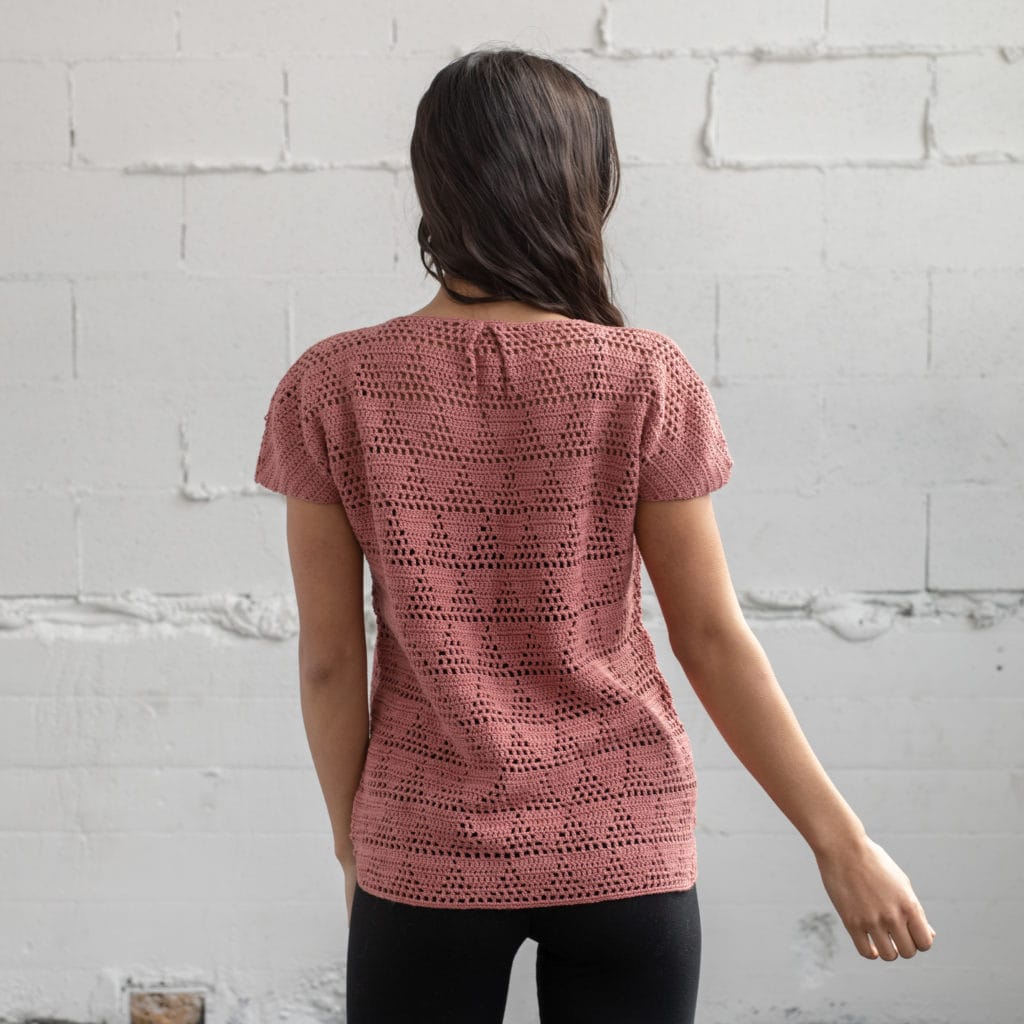 Forte Filet Tee. A hand crocheted t-shirt shown from the back, displaying a filet crochet pattern of triangles.