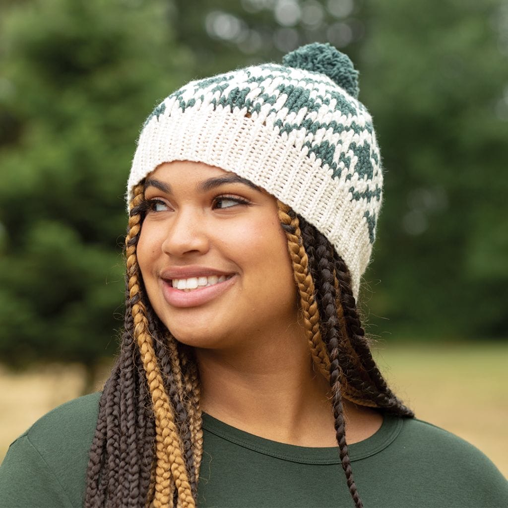 A woman wears a hand-crocheted hat made from 100% American Wool High Desert yarn.