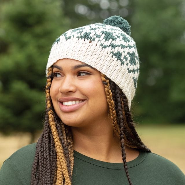 A woman wears a hand-crocheted hat made from 100% American Wool  High Desert yarn.